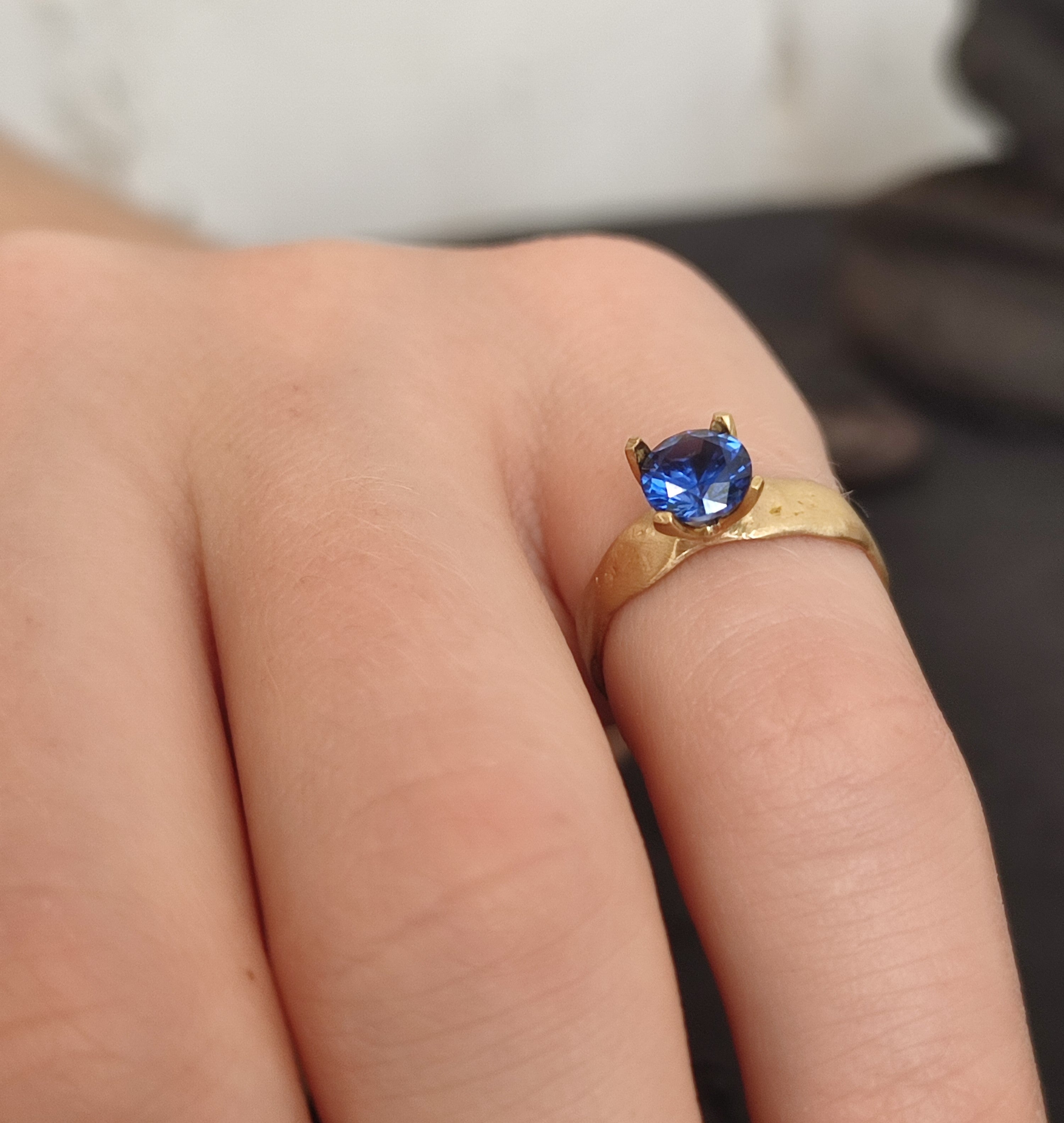 carved gold ring with sapphire