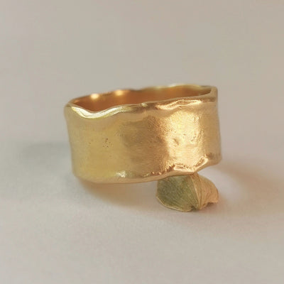 A rustic 18k wide solid gold cigar band